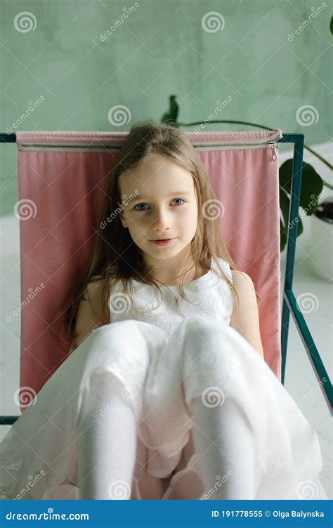 Cute Kid Girl 5 7 Year Old Sitting On Chair In Loft Style Room