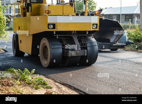 Heavy Vibration Yellow Steamroller Or Soil Compactor Working On Hot Mix