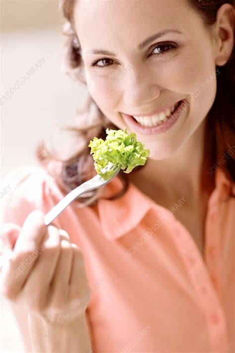 Woman Eating Lettuce Stock Image F Science Photo Library