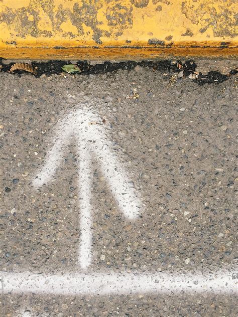 "Spray Painted White Arrow On Street With Yellow Curb" by Stocksy Contributor "Rialto Images ...