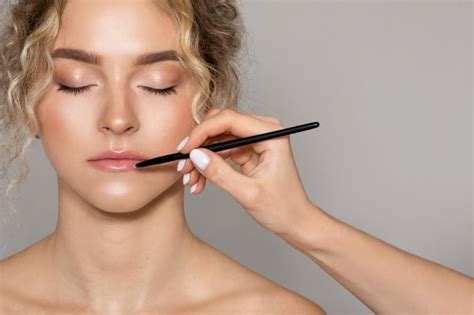 Premium Photo Professional Makeup Artist Doing Nude Makeup For Caucasian Woman Applying