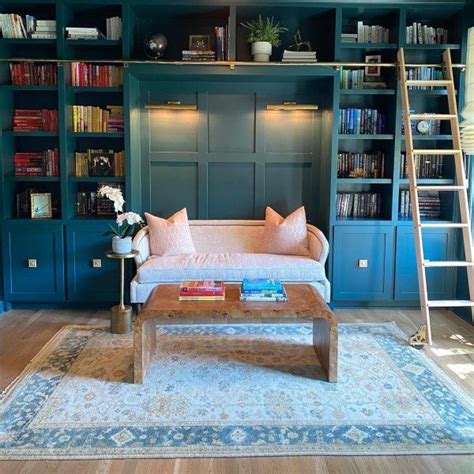 A Living Room With Bookshelves Couch And Coffee Table In It S Center