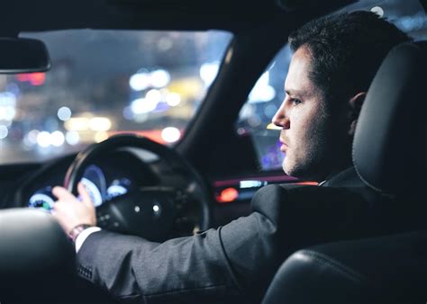 Premium Photo | Businessman driving a car at night