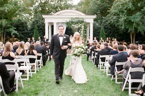 White Pillar Candles And Greenery Atop Cocktail Tables