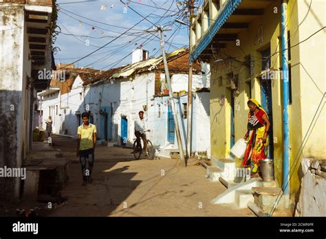 Khajuraho, Madhya Pradesh, India : Villagers walk in the whitewashed ...