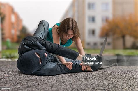 Woman Fighting With Armed Thief With Knife Self Defense Concept Stock