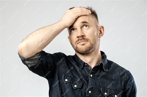 premium photo portrait  upset young man isolated