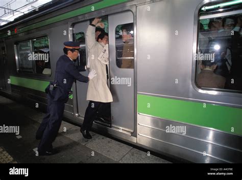 People getting shoved into subway train during Tokyo rush hour Stock ...