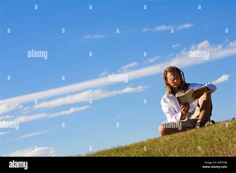 Man reading outdoors Stock Photo - Alamy