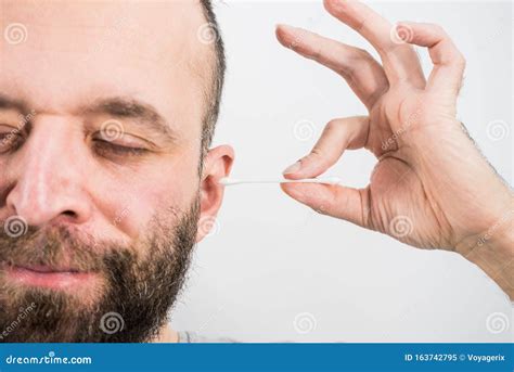 Man Removing Wax From Ear Using Q Tip Stock Image Image Of Care