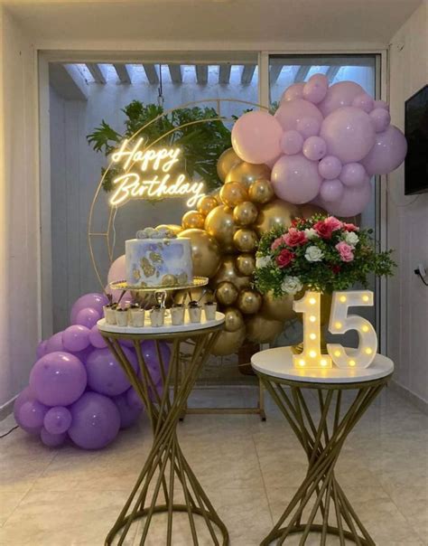 Two Tables Topped With Cake And Balloons