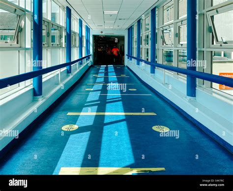 A Corridor In A Hospital With Windows On Each Side Giving A Bright And