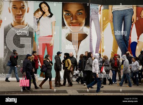 Clothing Ads dwarf passersby on 5th Avenue in NYC Stock Photo - Alamy