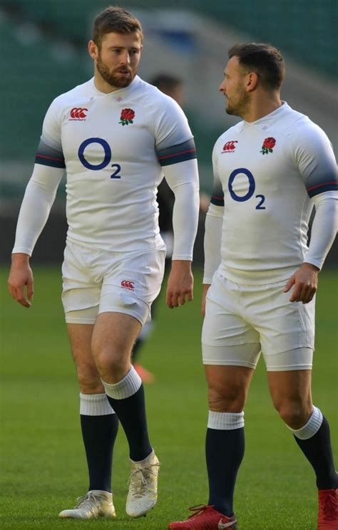 Two Rugby Players Are Standing On The Field