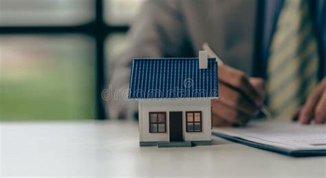 Real Estate Agent Or Bank Officer Working With Paperwork And Laptop