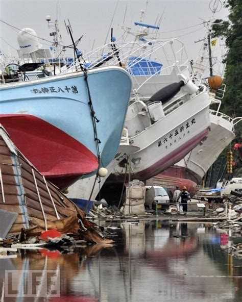 Two Boats Are Docked In The Water Next To Each Other And One Boat Is