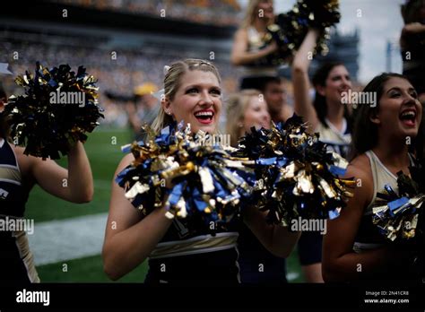 University Of Pittsburgh Cheerleaders Cheer In Front Of The Student