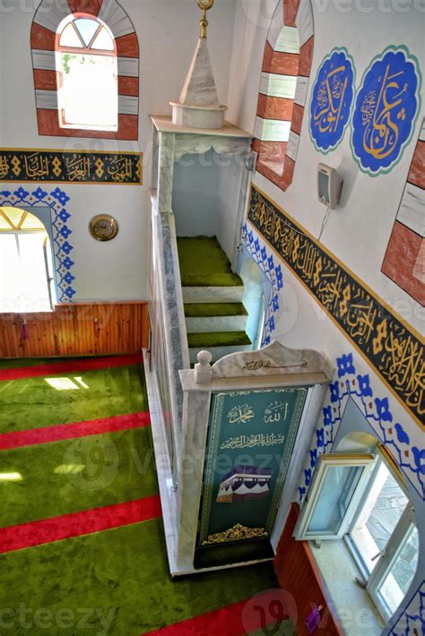 modest simple interior of a small Turkish village mosque with one miner ...