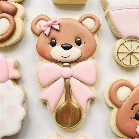 Decorated Cookies With Teddy Bears And Baby Carriages On Them Are