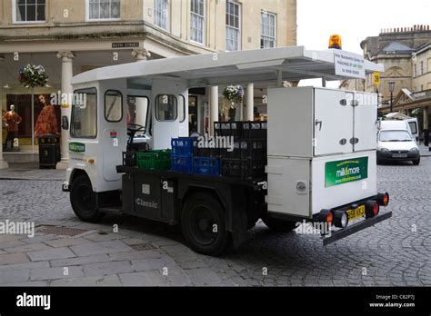 england uk electric milk float   cobbled street   historic city