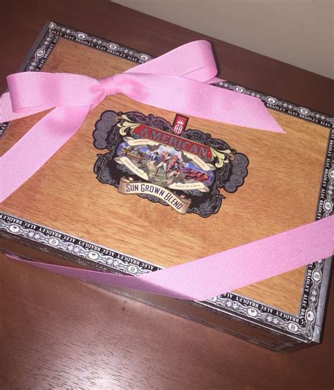 A Wooden Box With Pink Ribbon Tied Around It