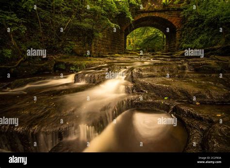 Small Red Brick Bridge Over The Stream At Falling Foss Waterfall