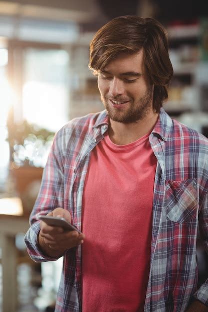 Premium Photo Smiling Man Using Mobile Phone