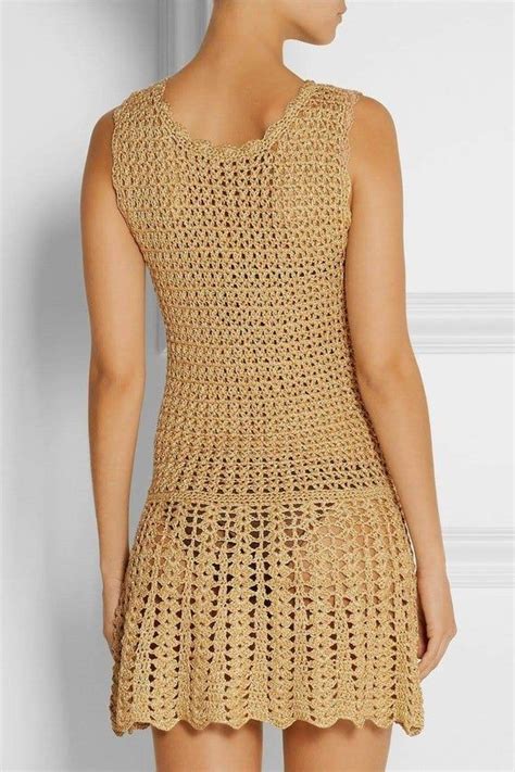 A Woman Is Wearing A Crochet Dress