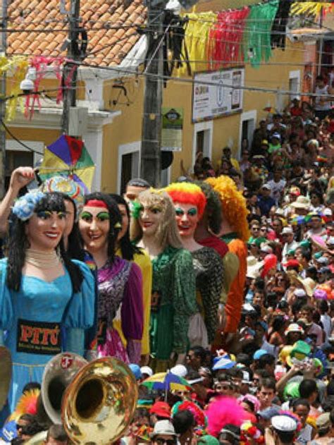 a group of people standing next to each other in front of a crowd with musical instruments