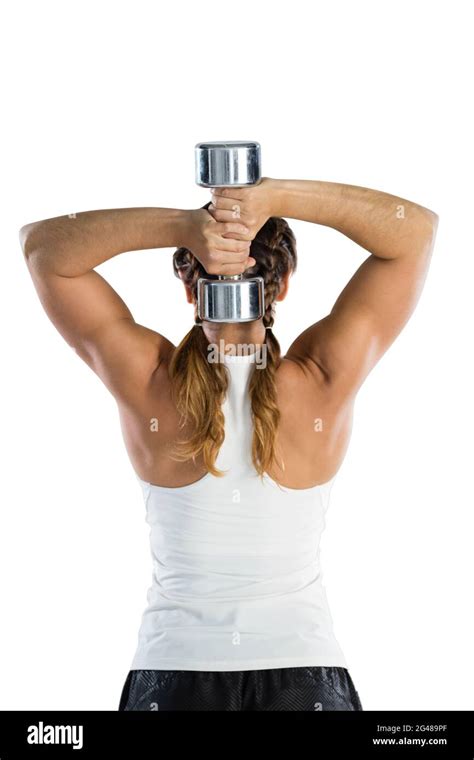 Rear View Of Female Rugby Player Exercising With Dumbbell Stock Photo