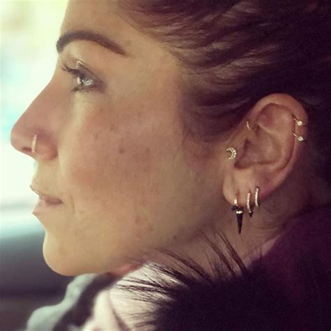 A Close Up Of A Person In A Car With Ear Piercings On Their Ears