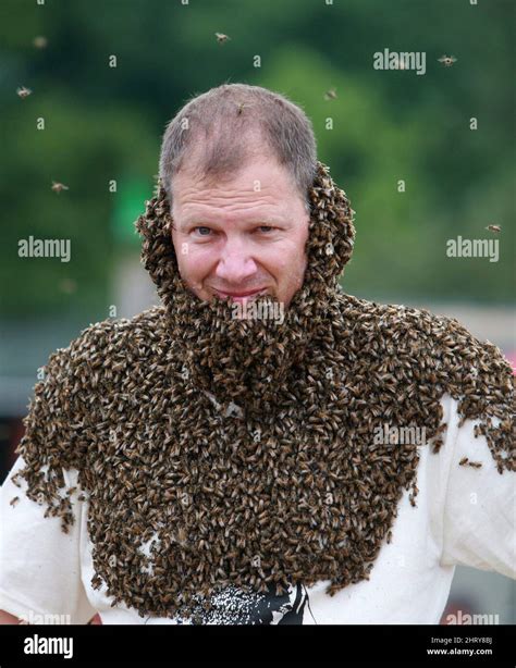 Albert de Vries of St. Thomas, Ontario walks while covered with over 5 lbs of honey bees, at the ...