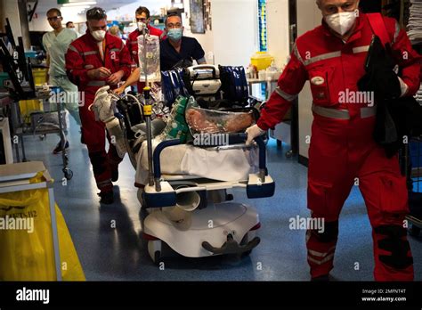 Medical Personnel Wheel A Bed With A Coronavirus Patient As They