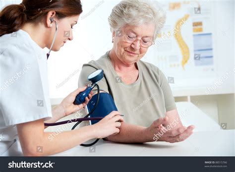 6248 Doctor Measuring Senior Patient Blood Pressure Images Stock