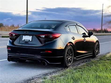 2015 Mazda 3 Black Car Parked in Front of Grass