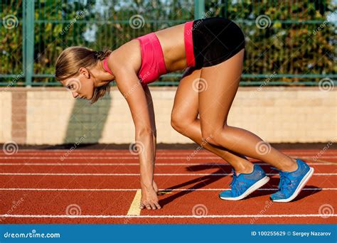 Young Woman Athlete At Starting Position Ready To Start A Race On