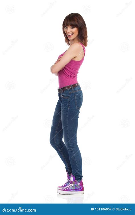 Smiling Woman Is Standing With Arms Crossed And Looking At Camera Side