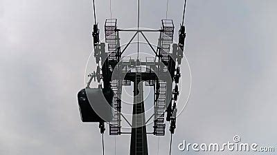 Ropeway Cable Car Cabins Silhouettes Are Moving Against Gray Sky In