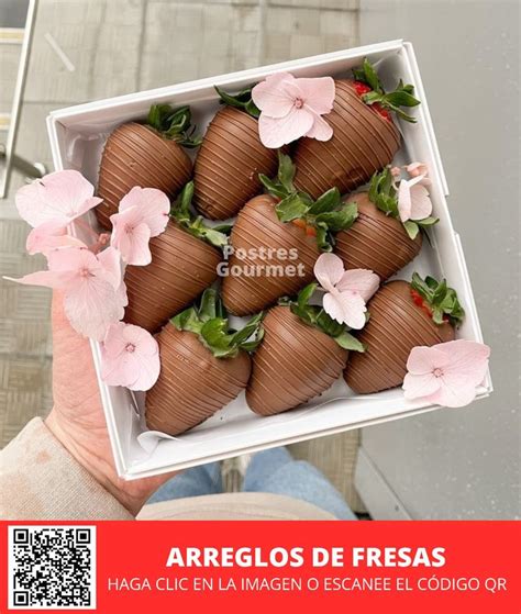 A Person Holding Up A Box Of Chocolate Covered Strawberries With Pink