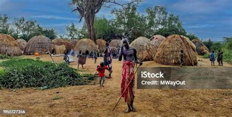 Men And Boys In Front Of Their Huts In A Mursi Tribe Village In Omo