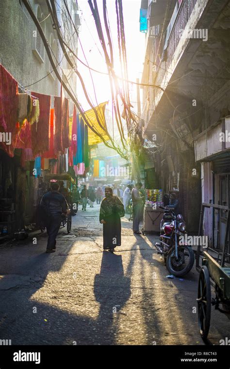 Daily life on the streets of Old Delhi at sunset. Old Delhi is a walled ...