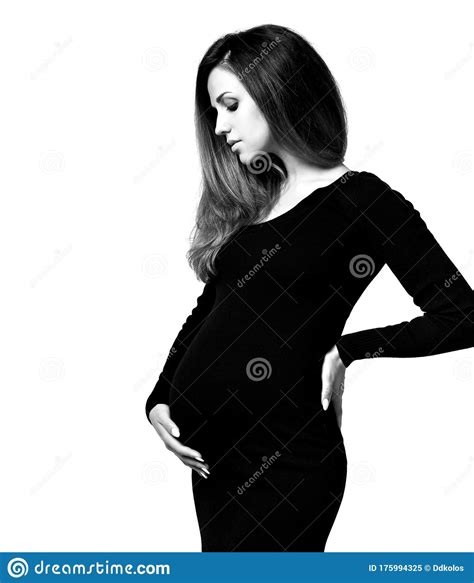 Black And White Photo Of Pregnant Female In Tight Dress She Put Hands On Her Belly Posing