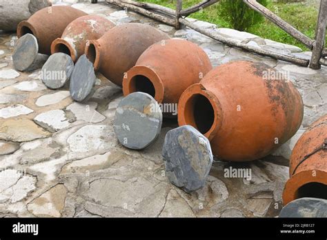 Row Of Georgian Traditional Wine Making Clay Vessels Kvevri With Stone