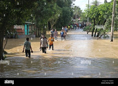 People Walk In Flood Water At The Road After A Widespread Flash Flood