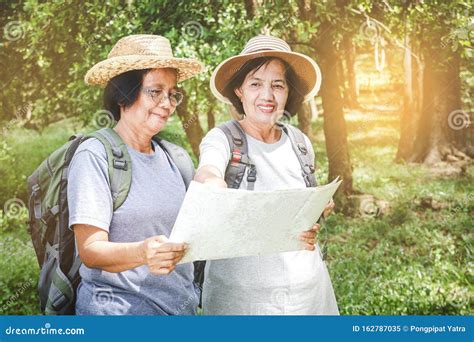 Two Old Women Hiking Backpacking And Carrying Maps Stock Image Image