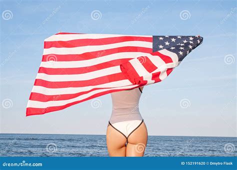 Beautiful Patriotic Woman Holding An American Flag On The Beach Usa