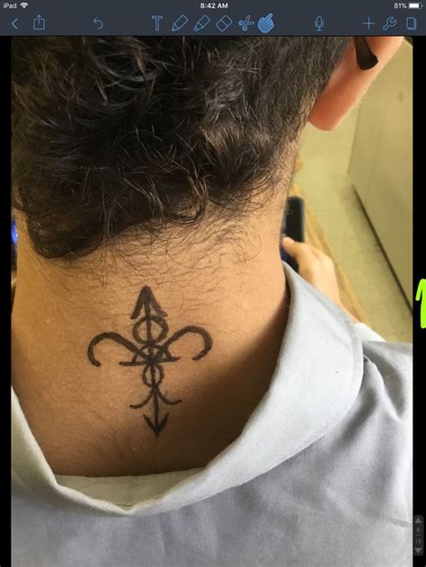 A Person With A Tattoo On Their Neck And Behind His Head Is An Image Of