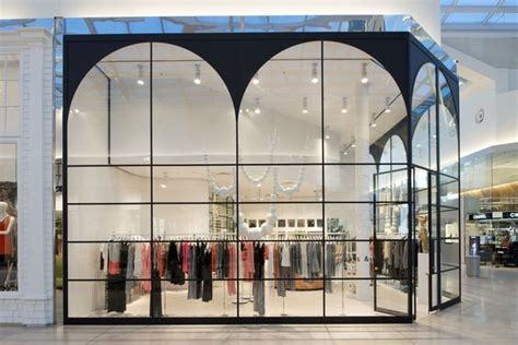 The Inside Of A Clothing Store With Glass Walls