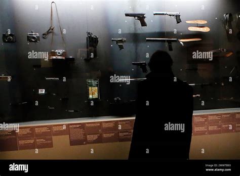 A visitor looks at real-life spy gadgets and weapons of secret agents ...