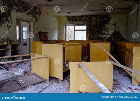 The Image Shows A Dilapidated Room With Crumbling Walls Debris On The